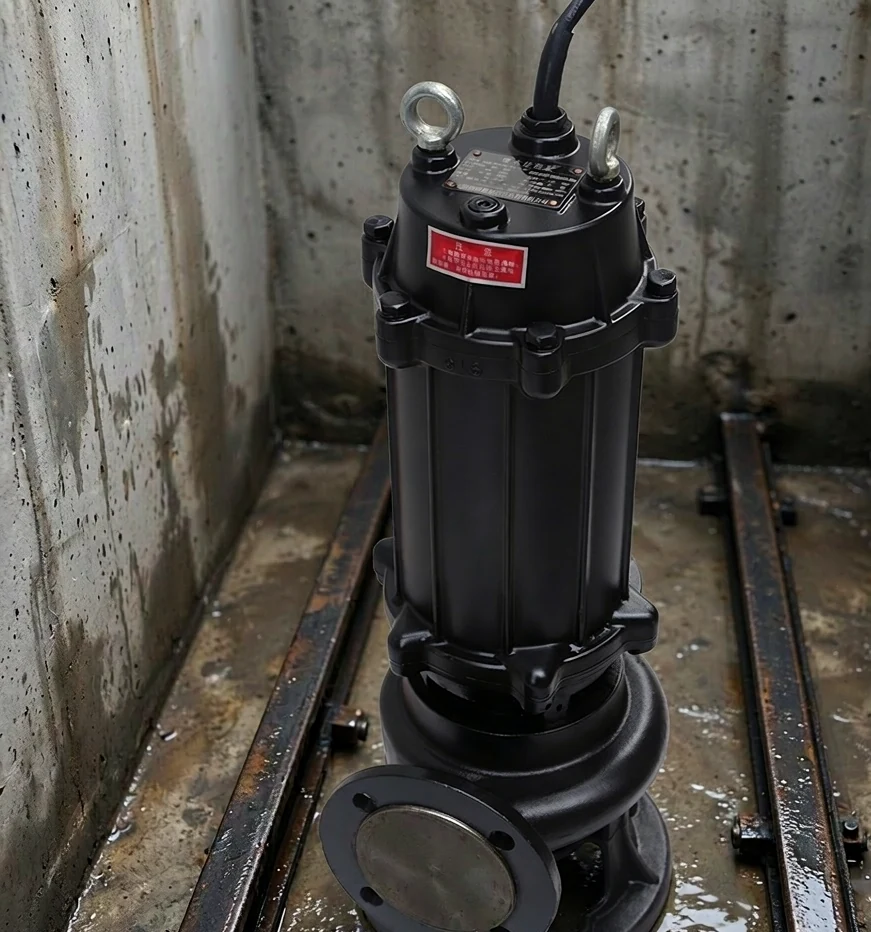 Submersible sewage pump installed at the bottom of a concrete wet-well sump pit for continuous-duty operation