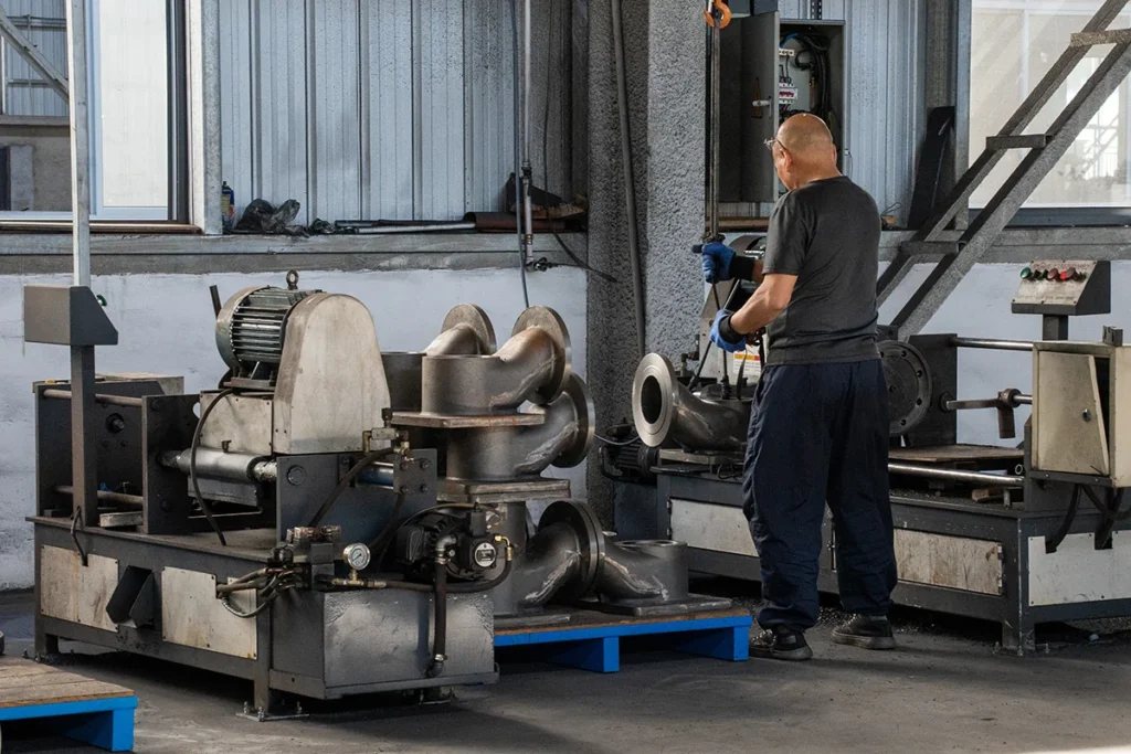 technician machining a stainless steel pump volute for a high pressure boiler feed pump